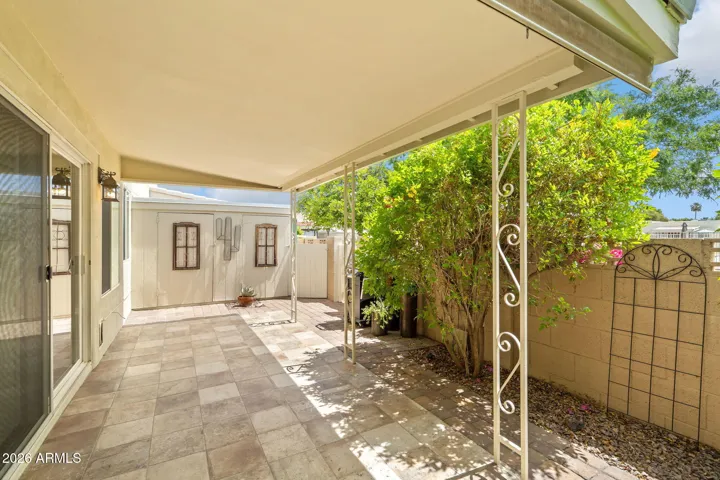 Covered patio with more tile and planting spae.