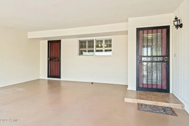 Two entries to home with quality security/screen doors. Carport floor has an epoxy finish.