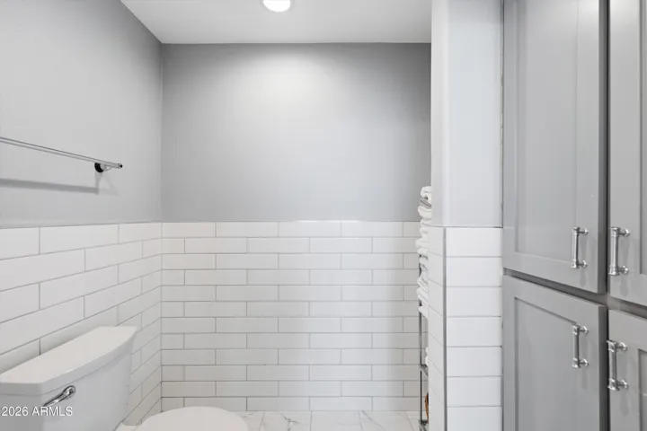 Separate bath closet and linen storage.