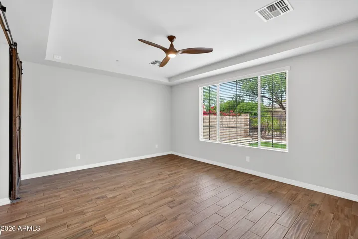 Spacious primary suite with large windows to bathe the space in natural light