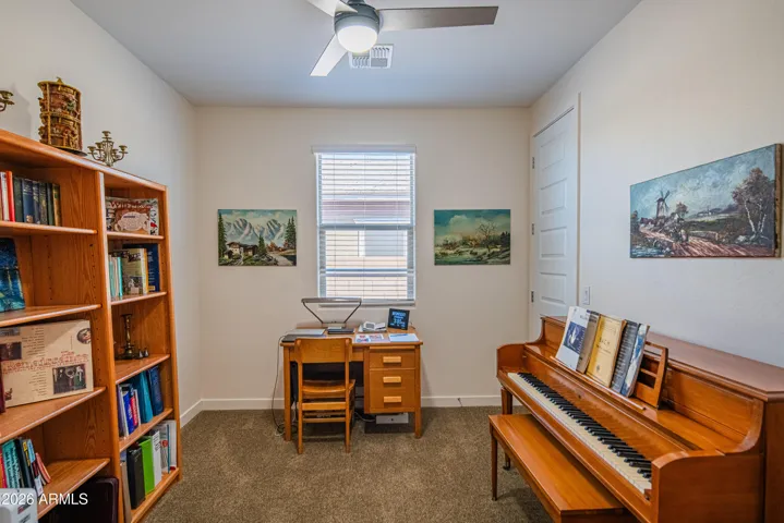 Flexible room ideal for a home office or study, featuring natural light and functional layout. Perfect for remote work or creative space in this modern Peoria home.