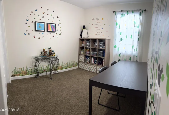 Secondary bedroom with ample space, natural light, and neutral finishes. Ideal for guests, family, or a hobby room in this well-designed Peoria home.