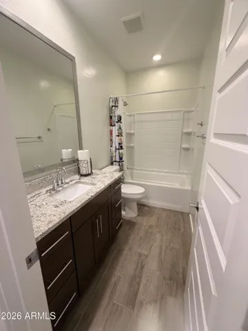 Stylish bathroom with granite countertops, modern fixtures, and full tub/shower combo. Clean design and updated finishes enh
