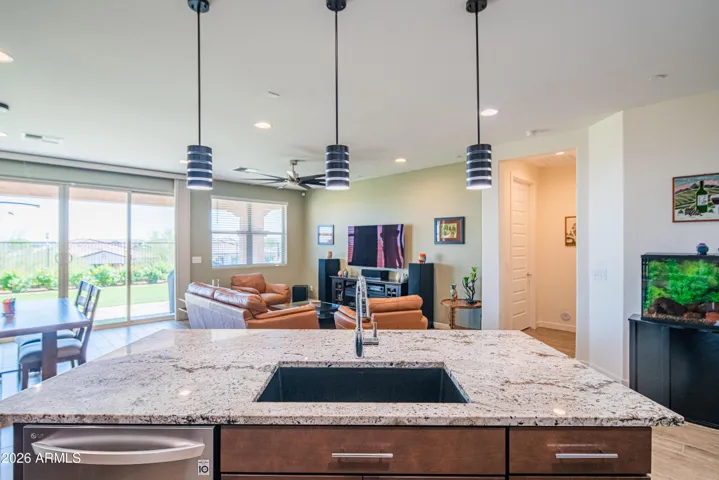 Bright open-concept living space connecting the kitchen, dining, and great room. Designed for comfort and flow, featuring energy-efficient lighting and seamless indoor-outdoor access.