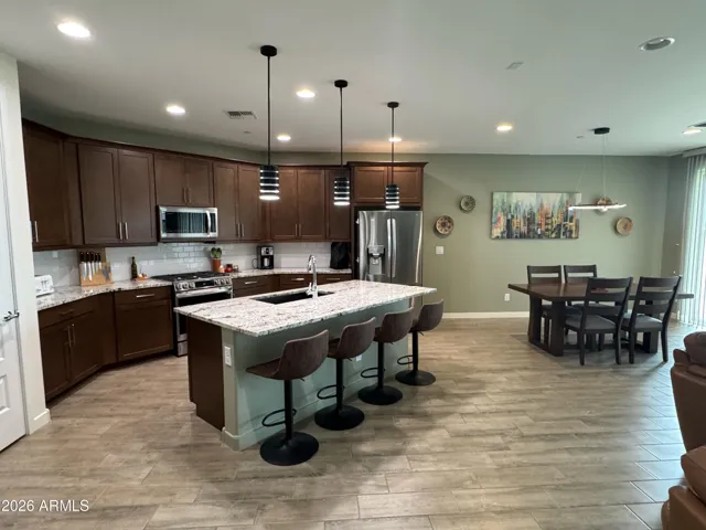 Beautiful kitchen with granite countertops, stainless steel appliances, and ample cabinetry. Functional layout with modern finishes enhances everyday living in this Peoria home.