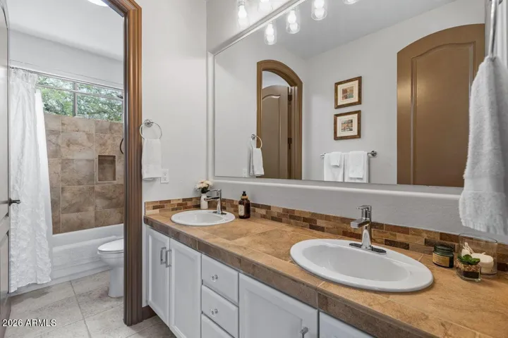 Beautiful bathroom with double sinks and updated lighting and extra storage.
