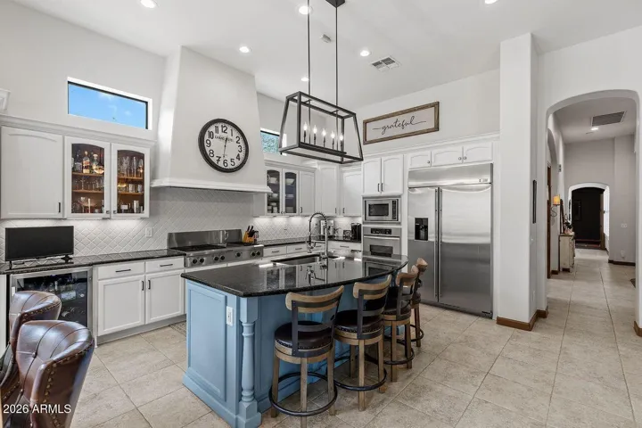 Beautiful White Cabinets with stainless appliances white designer back splash and undermount mood lighting just for starters.