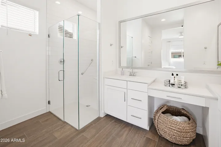 Walk in shower with double sinks and vanity
