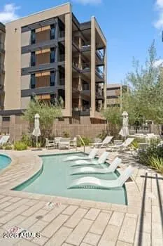 Portico delivers an elevated living experience with resort-style amenities including a pool, two spas, clubhouse with kitchen, fitness center, BBQ areas, dog park, and scenic walking paths throughout the community.