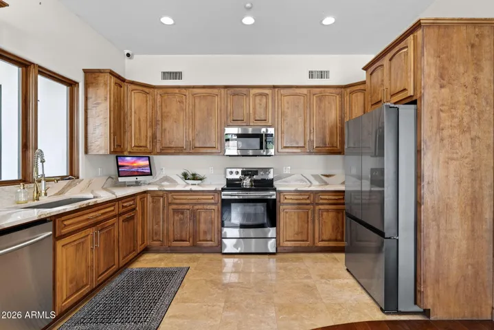 A full kitchen greets you in the attached casita featuring range and microwave, full size refrigerator, freezer and dishwasher.