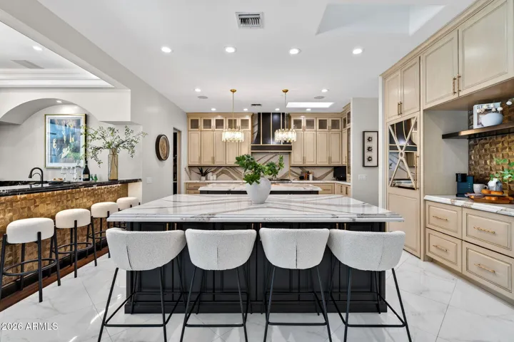A grand dual island kitchen is a chef's dream and features incredible custom details.