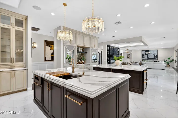 Mirrored panels hide the refrigerator and freezer making this kitchen space feel expansive and chic.