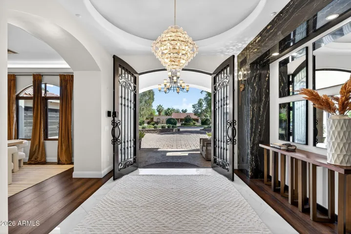 Custom wrought iron and glass doors welcome you to the grand foyer of this elegant estate.