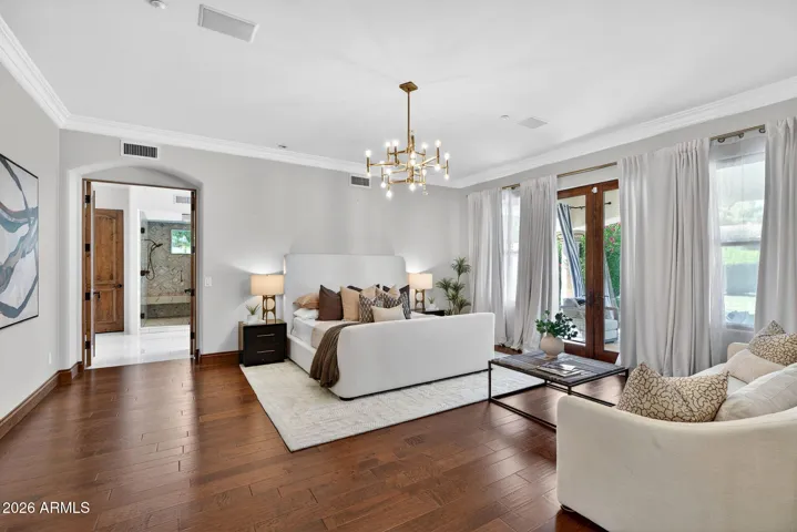 A grand primary suite welcomes you with beautiful French Doors leading to the covered patio and lush backyard space.