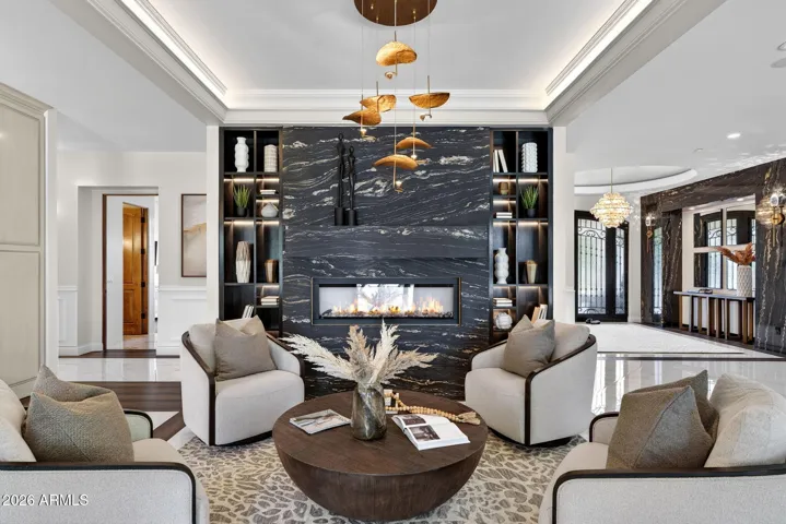 The marble clad fireplace invites you to take a seat and enjoy the glow.