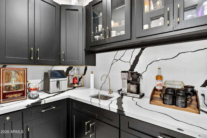 A spacious back kitchen is great for hiding appliances and additional storage.