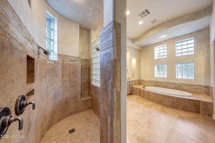 Walk-in shower accented with glass block details