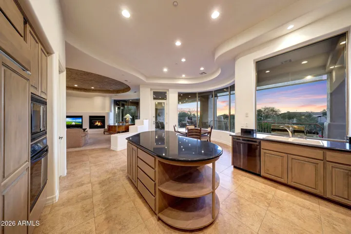 Generously sized island complemented by granite countertops
