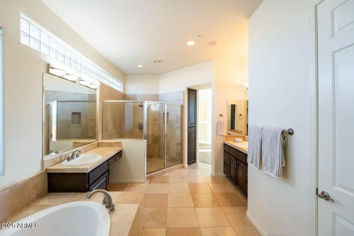 Separate soaking tub and walk-in shower.
