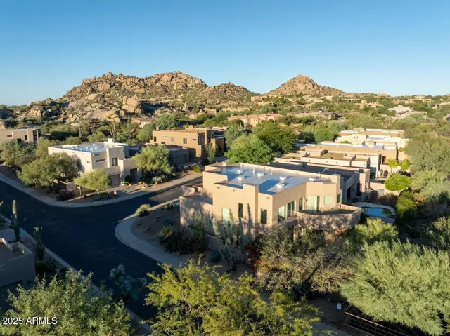 Surrounded by the striking boulders and desert landscape of Troon North, this 4-bedroom residence sits within the gated community of Pinnacle Canyon.