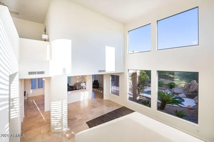 Spacious natural light filled room with wall of glass.