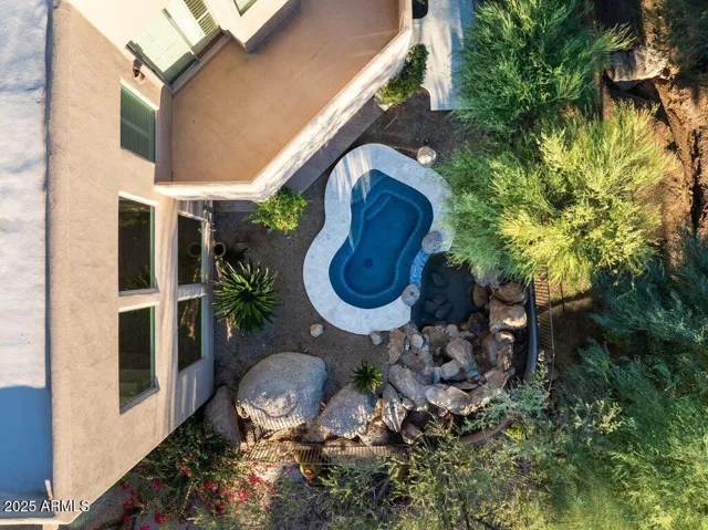 The primary bedroom enjoys a private balcony with views of the grounds.