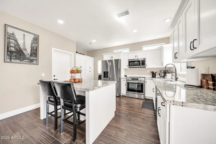 UPGRADED APPLIANCES, GRANITE, WHITE SHAKER CABINETS.