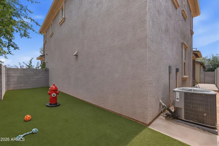 Virtually staged to show a dog run area in the additional side yard