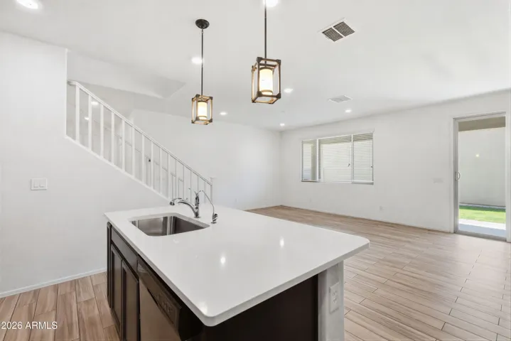 Kitchen features Quartz counters, stainless steel appliances, walk-in pantry, pendant lighting, recessed lighting