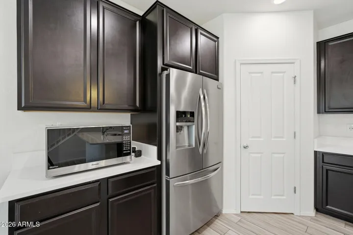 Kitchen features Quartz counters, stainless steel appliances, walk-in pantry, pendant lighting, recessed lighting