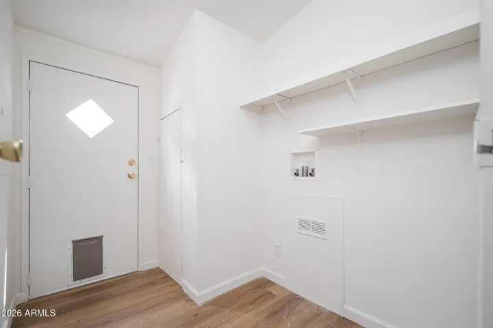 LAUNDRY ROOM, WITH REAR ENTRY DOOR TO CARPORT.
