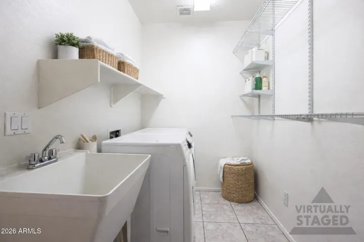 Main floor laundry room located off the three care garage on the way into the home.