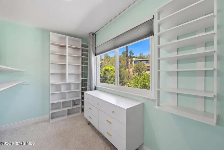 Walk in closet, with built ins, natural light.