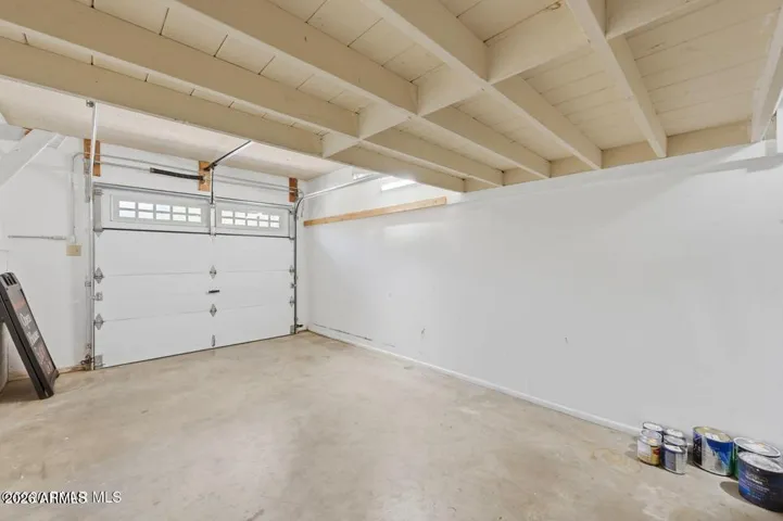 Oversized 1 car garage has a storage loft.