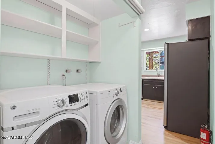 Laundry with shelving. There is a pull down shade cover.