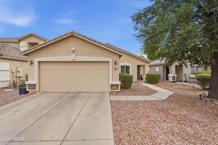 Well-maintained exterior, extended driveway, and 2-car garage, complemented by low-maintenance desert landscaping.