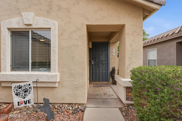 Inviting covered entry with a private walkway and charming front porch area, creating a warm and welcoming first impression.