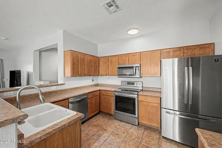 Lots of cabinet and counter space in this kitchen and a breakfast bar too!