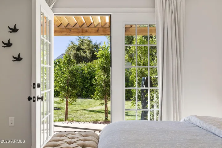Guest house bedroom french doors to orchard