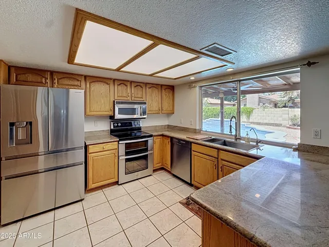 Kitchen has solid oak cabinets, granite counter tops and stainless steel appliances