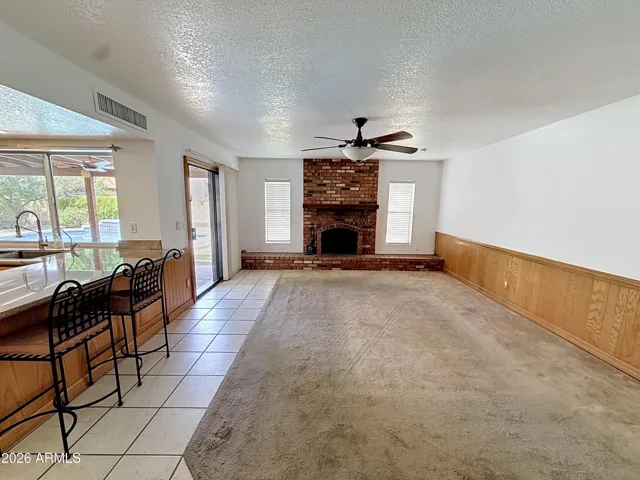 Family room with fireplace and arcadia door to pool