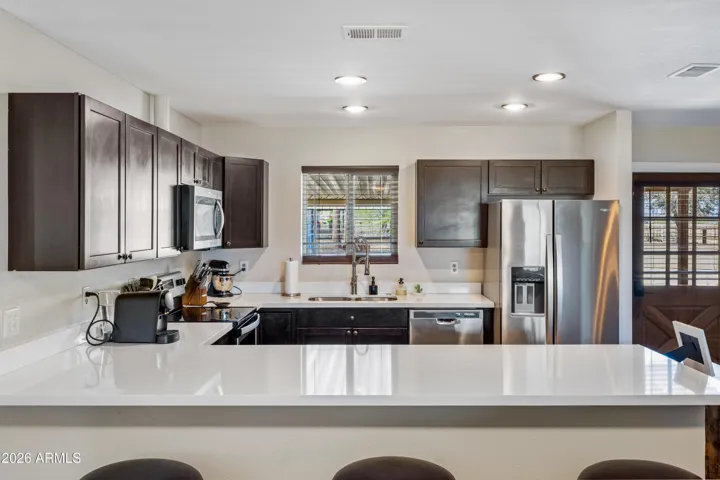 Kitchen with Quartz Counter and SS Appliances
