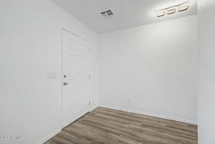 Welcoming interior foyer with clean finishes, and wood-look flooring
