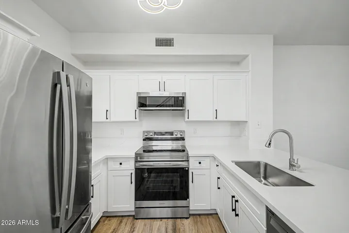 Modern kitchen with stainless steel appliances and a kitchen peninsula