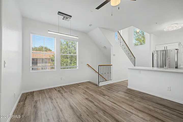 Great room with natural light and hard wood flooring