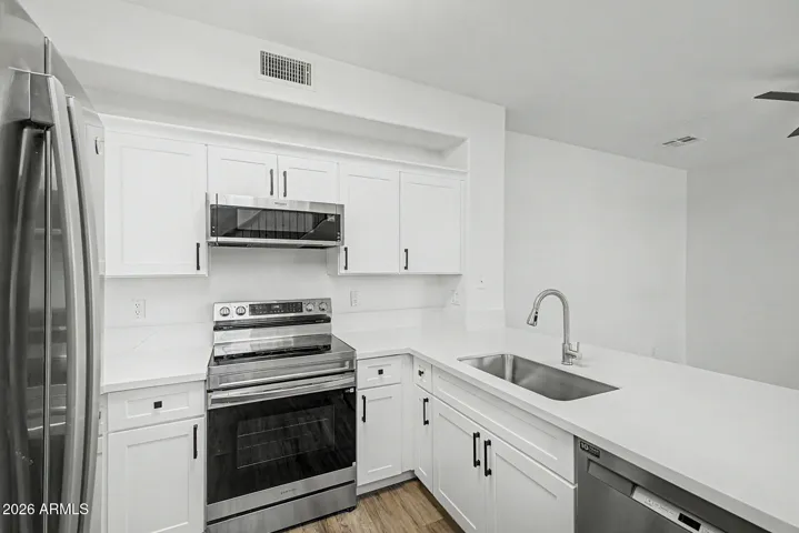Modern kitchen with stainless steel appliances and a kitchen peninsula