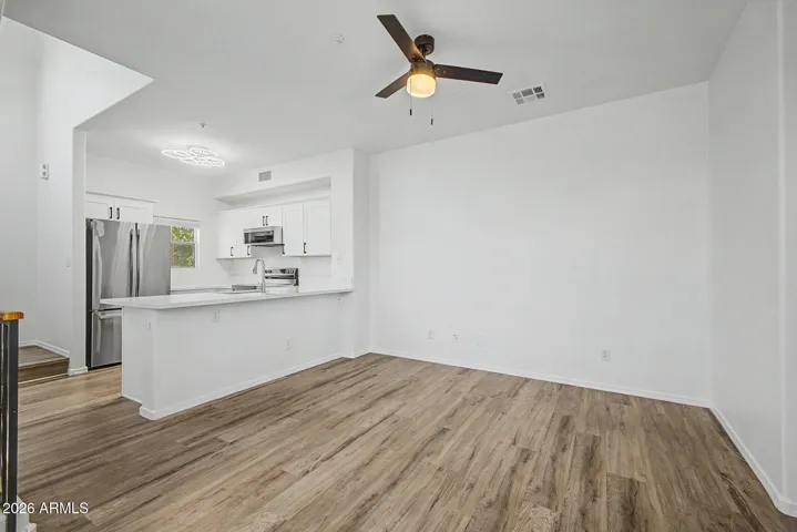Great room with natural light and hard wood flooring
