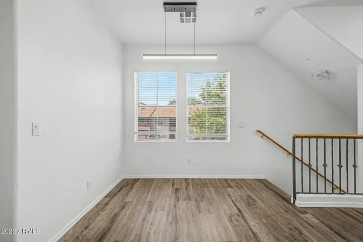 Bright upstairs space with window and stair railing