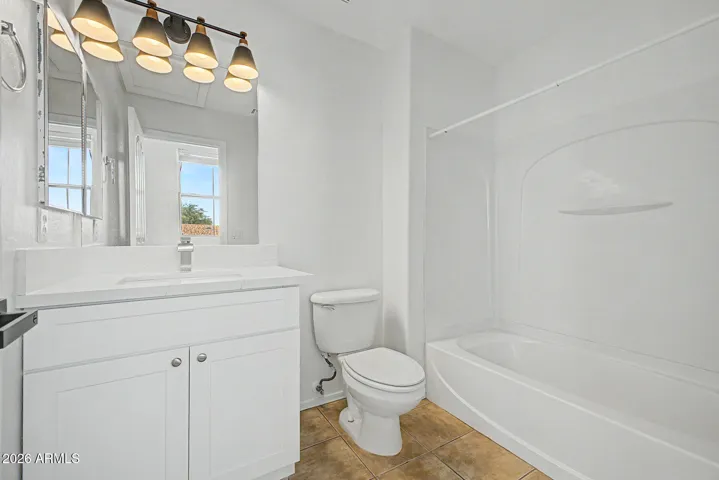 vanity mirror, multi light fixture, bathtub