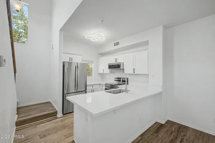 Modern kitchen with stainless steel appliances and a kitchen peninsula